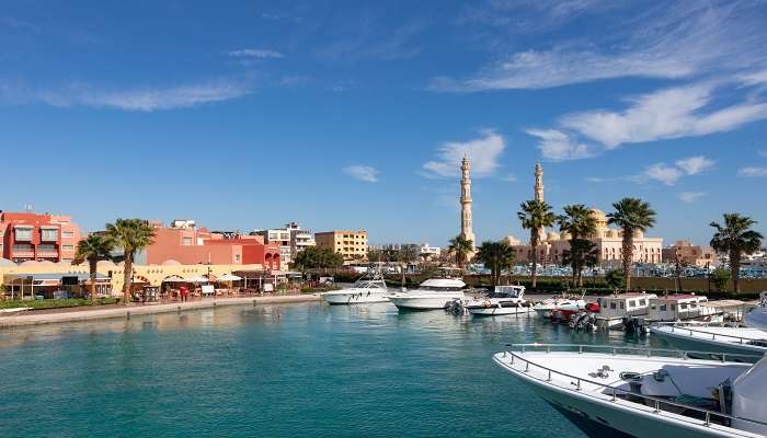 A bustling marina with boats and buildings to engage in the best things to do in Hurghada. 