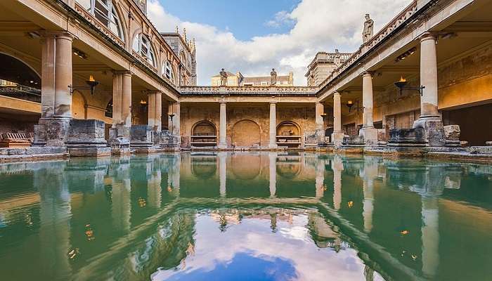 Roman-inspired garden buildings in a serene landscape setting.