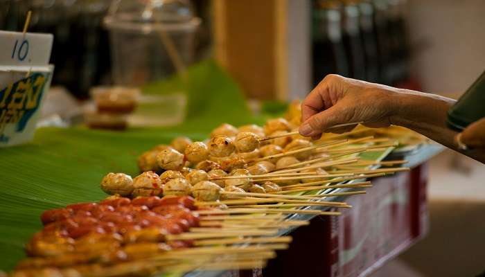 Two chefs at Kata Beach serve a relaxed meal. 