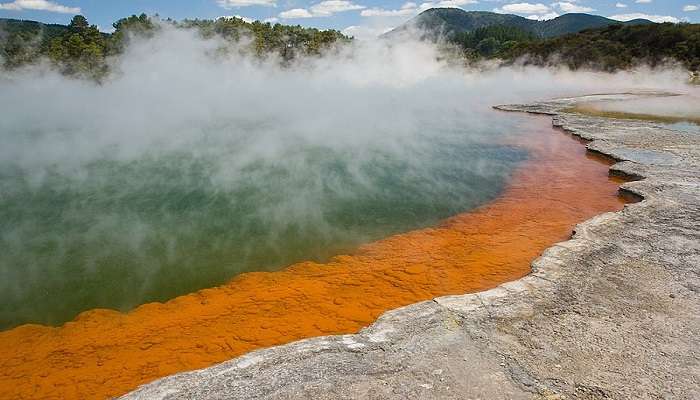 Stunning view of the Champagne Pool at Waiotapu Thermal Wonderland, with vivid hues and geothermal activity.