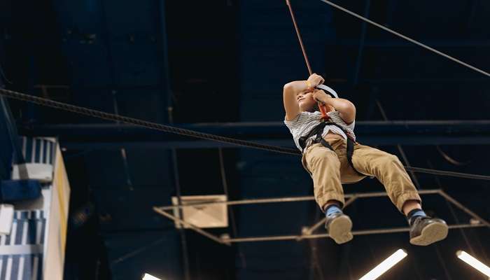 A guy enjoying zip lining ride in Harbor Land 