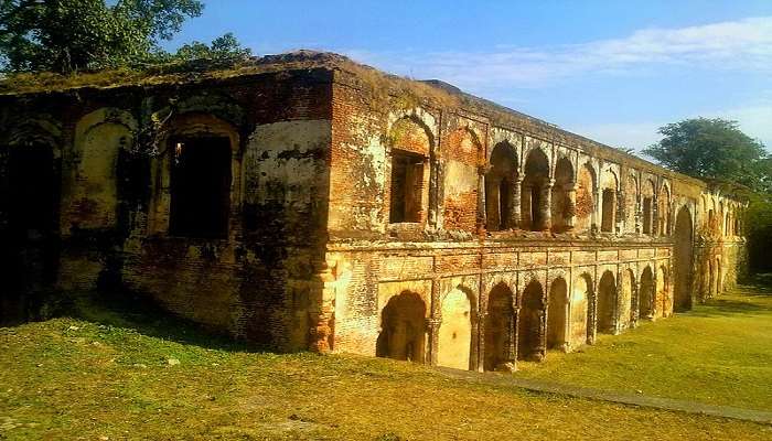 Scenic view of Sujanpur Fort with lush green hills in the background.