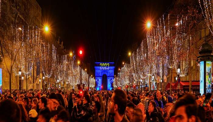 Experience the dazzling lights on the Champs-Elysées, one of the best things to do at Christmas In Paris.